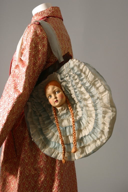 Anonyme, circa 1970,

An amusing bag... The pleats made in two different shades of blue silk organza frame the red hair doll's head