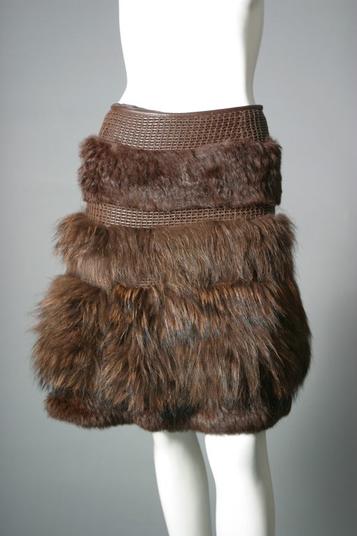 Sonya Rykiel, Paris, 2004

Lovely and amusing skirt of chestnut colored Marmot , composed of bands of woven dark brown leather interspaced with Marmot fur, in bands of long and shaved hair, one large flounce of fur gives volume to the lower part