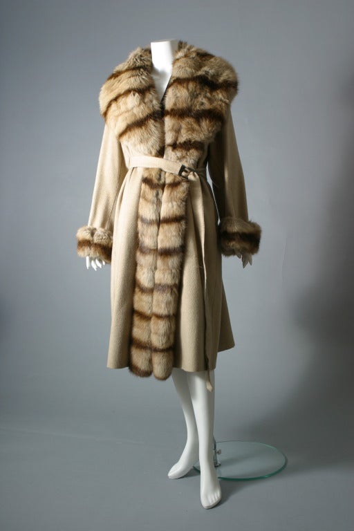 FENDI furs, by Karl Lagerfeld

Reversible 100% beige cashmere coat. Large collar, front and cuffs, in Marten and Canadian sable fur. The belt with the F for Fendi in tarnished silver, two side pockets, un-lined, un- labelled.
Ample and very