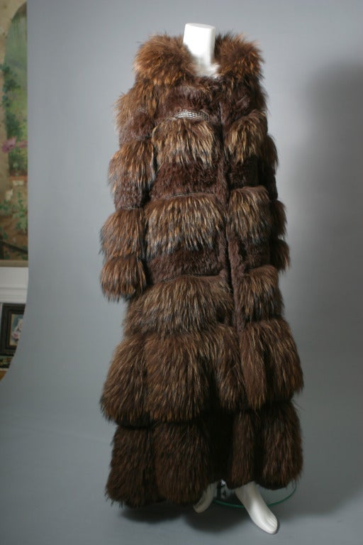 Sonya Rykiel, Paris, circa 2004,

Fabulous coat of chestnut colored Marmot , composed of bands of woven dark brown leather interspaced with Marmot fur, in bands of long and shaved hair, two large flounces of fur give volume to the lower parts of