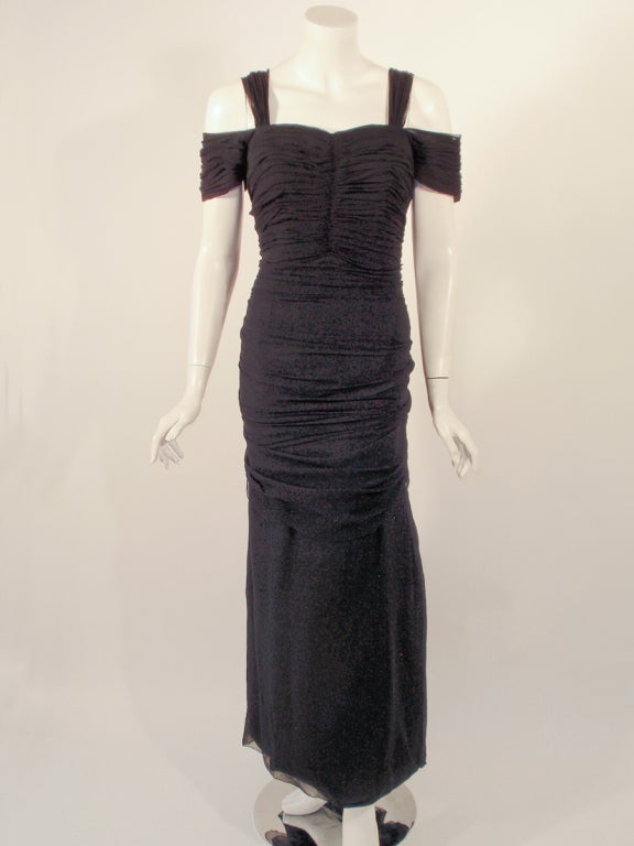 This is a lovely vintage evening gown from Eleanora Garnett. It is made of a draped black chiffon with a taffeta lining. there is black velvet bow cluster at the back zipper closure.
The bodice is boned. 

Measurements:

Bust: 32