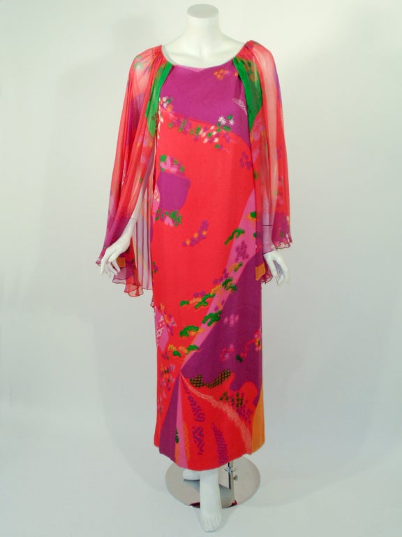 This is a gorgeous and flowy gown from Japanese designer Hanae Mori. It is made of 100% silk chiffon with a silk lining. The sleeves are an open bell shape that drapes off the shoulder.
This dress belonged to legendary actress Loretta Young.
This is