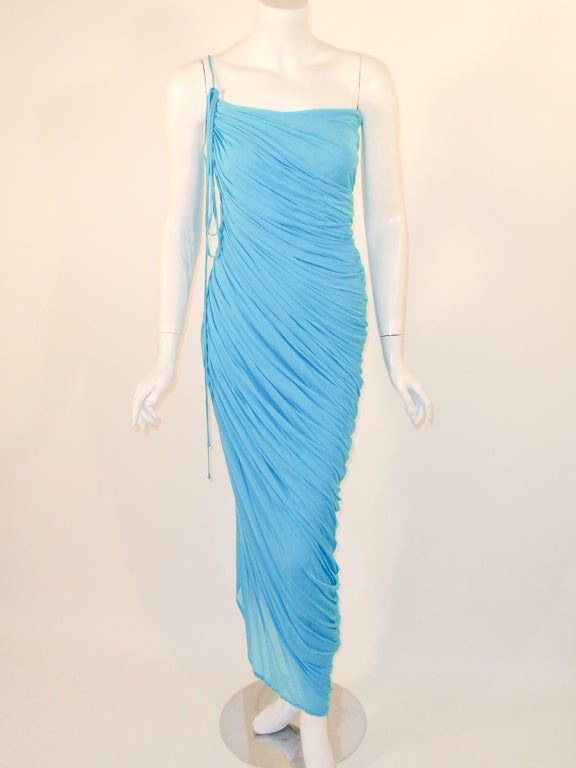 This is a slinky, sexy evening  gown from Halston. Made from a jersey knit, with draping from the side and one shoulder strap that ties on the right shoulder. There is a side zipper. Originally purchased from Amen Wardy.
Un-stretched
Measurements: