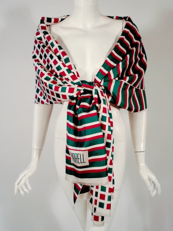 This is a fantastic large size scarf from Norman Norell. It is 100% Silk. Half of it is a stripe pattern and the other half is a check pattern.

Measurements:

Length: 86