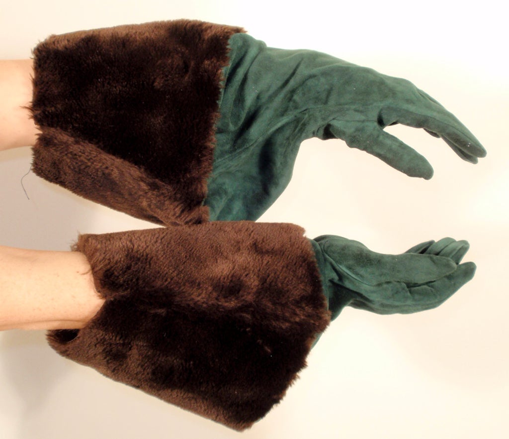 This is a very high fashion pair of gloves from Yves Saint Laurent Rive Gauche. They are made from a butter soft green suede that slouches into a brown faux fur gauntlet. They would look great over a cool weather jacket.

Measurements:

Length: