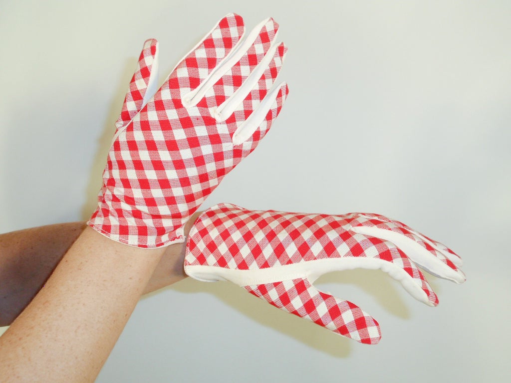 This is a charming pair of vintage gloves made by Claire McCardell. They are red and white gingham check fabric with white palms. There is a little bit of stretch.

Measurements:

Length: 8