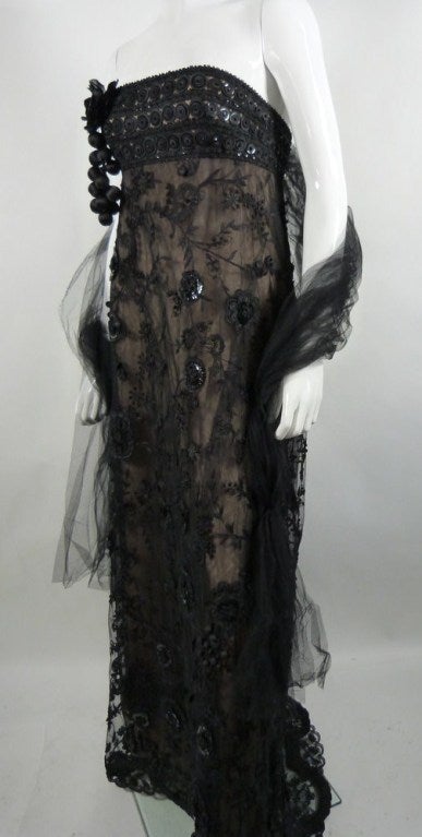 This is a stunning contemporary Oscar de la Renta black lace dress with detachable brooch. Originally retailed for $8,500.00.

This Oscar de la Renta dress is available to be viewed privately in our Beverly Hills boutique couture salon during