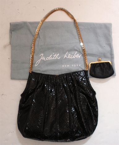 This is a black snake print handbag by Judith Leiber, from the 1990's. The handbag has two chain straps, one gold and one silver, one main compartment with one zip pocket, includes a black leather coin purse and original dust bag.<br />
<br