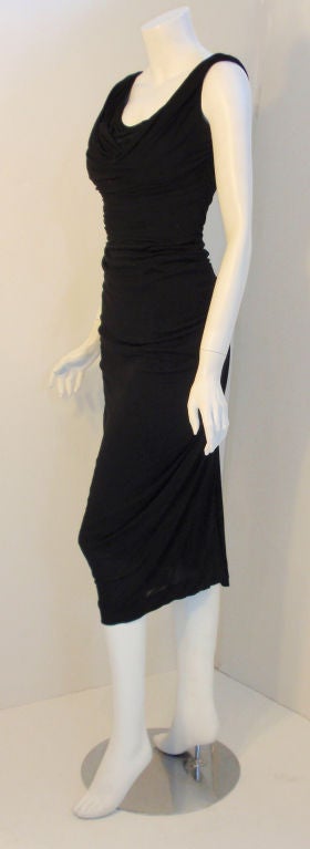 This is a vintage black cocktail dress Attributed to: Ceil Chapman. 
Circa 1940's. 
Label missing.
The piece is skilfully ruched, with a scoop neckline front and back.
It has zipper up the back.
This beautiful piece is very Marilyn Monroe.

FABRIC: