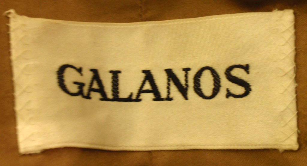 This is a heavy weight dark brown camel wool double breasted coat by Galanos, from the 1960's. This coat has two front flap pockets and a silk lining.

Measures:

Length: 44 1/2