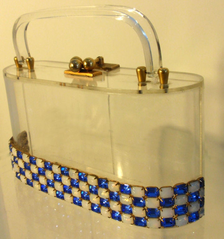 This is a very rare clear lucited purse with white and blue rhinestones from the 1950's, made by designer Wiesner of Miami, Inc. It has one 2