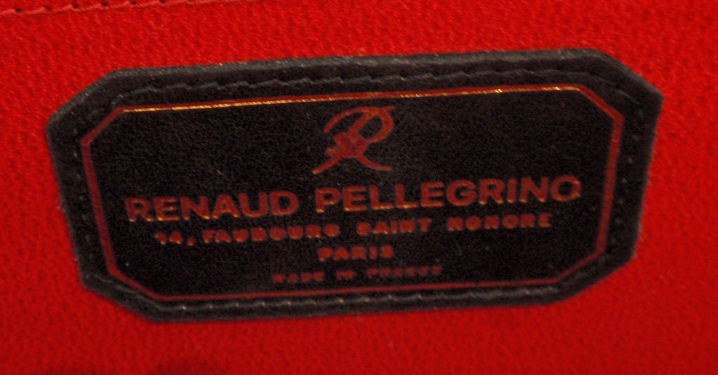 This is a collectible black vintage alligator handbag by Renaud Pellegrino, from the 1990's. The handbag has two 12 1/2