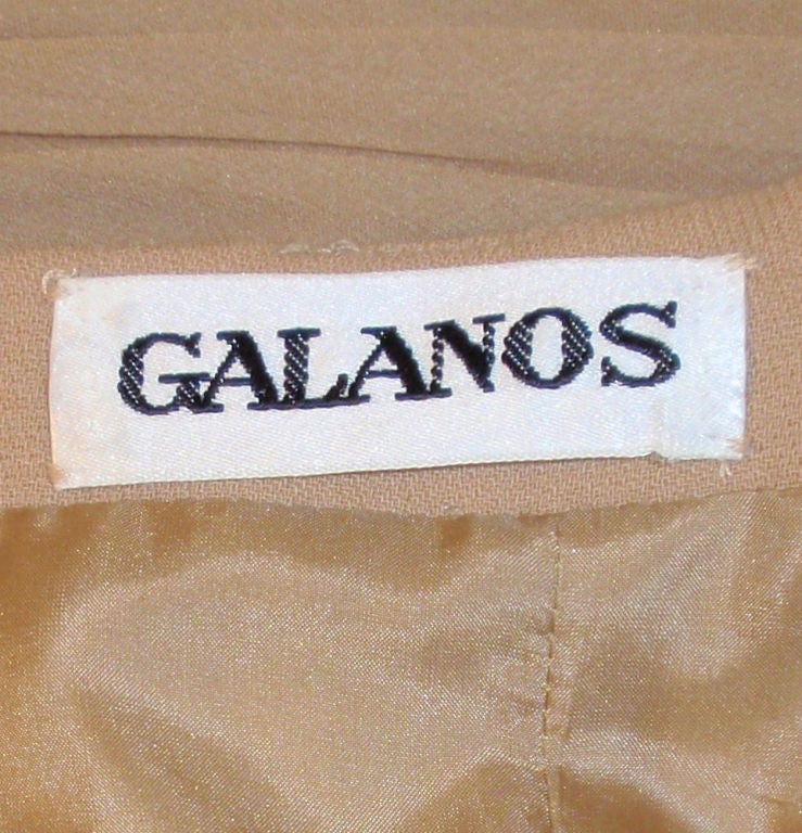 This a fantastic contemporary cocktail dress made by James Galanos. It is made of a camel colored ruched chiffon outer and a rayon base for structure, and is fully lined. It has spaghetti straps and a zipper up the