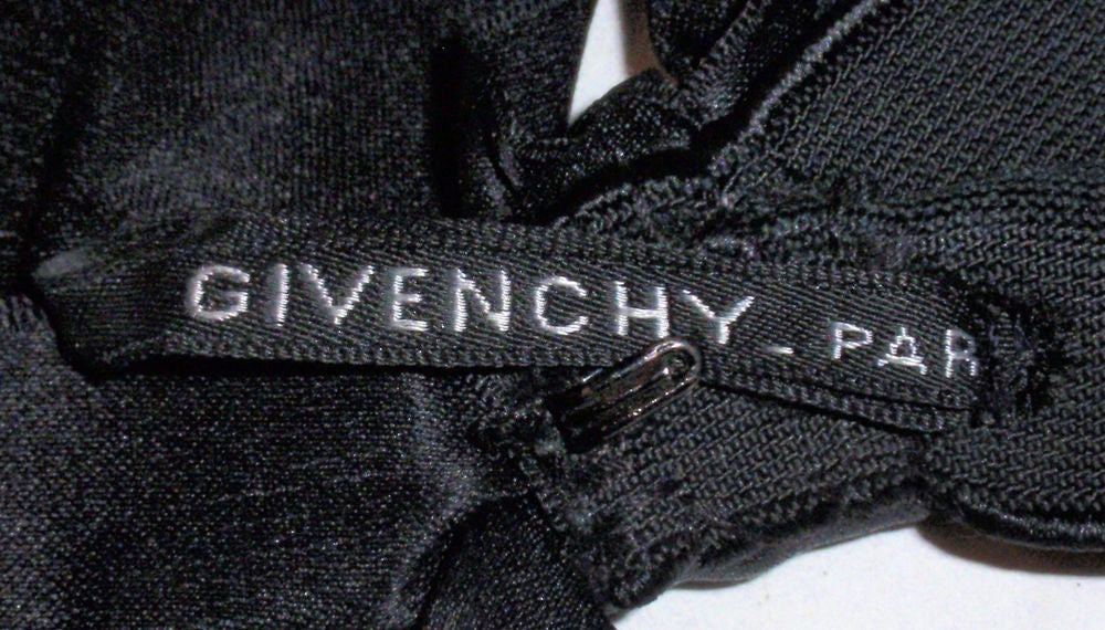 this is a beautiful custom-made Couture cocktail dress from Givenchy. It is made of black velvet and has a lace bodice and hem. There is a zipper up the back, on the side and two zippers on the hem of the sleeve. It has a silk lining. Included is a