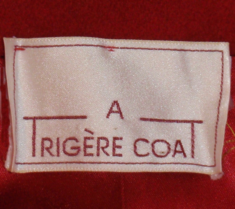 This is a lovely overcoat from Pauline Trigere. It is made of a red soft but heavy wool, with red satin lining. There are four chrome buttons down the front and 2 slash pockets.<br />
<br />
Measurements:<br />
Length (Shoulder to hem): 47
