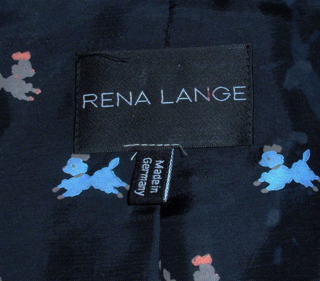 This is a classic skirt suite from Rena Lange. It is made of a soft wool blend fabric, with a knit panel on the sleeves. The lining is a nylon print with blue and gray poodles. Made in Germany.

Size 8