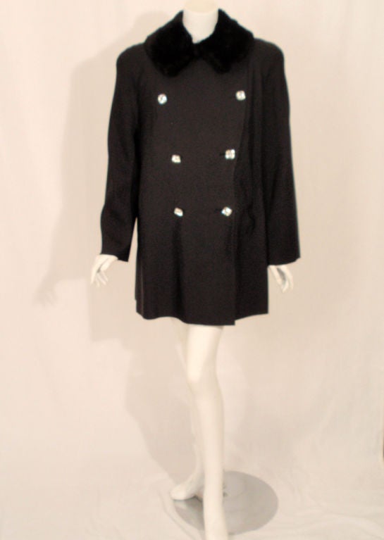 Elegant 1950's black faille coat with a double breasted square rhinestone button front, seamless shoulders with diagonal seams extending from the collar to the under arm, and a sheared beaver fur collar. The coat is lined in black wool crepe with an