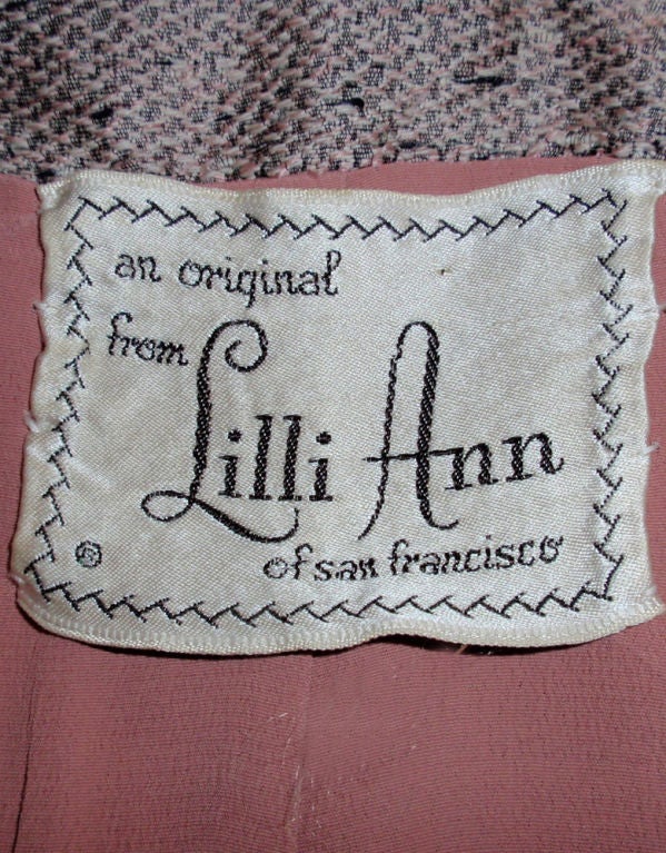 This is a knock-out vintage 2 piece skirt suit from Lilli Ann. Very rare and highly collectible. Both pieces are made of a lavender shantung with a crepe lining. The jacket sis fitted with a full peplum and the skirt is a pencil style with a side