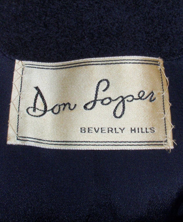 This is a classic style vintage overcoat from Don Loper. It is made of a soft but heavy navy blue wool with a navy blue crepe lining. There are 2 patch pockets on the front and 3 big buttons.<br />
<br />
Measurements:<br />
Length(Shoulder to
