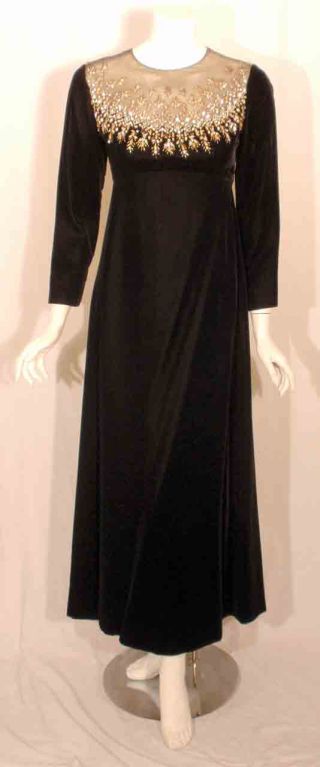 This is a long black velvet evening gown by Malcolm Starr, from the 1980's. The gown has beading and rhinestones around the front and back neckline, empire waist, black lining, and a zipper up the back.

Measurements:

Size# 8

Length