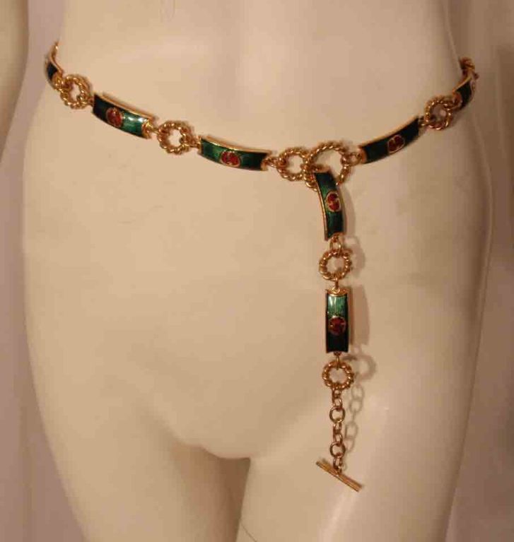 This is a vintage green, red and gold logo chain belt by Gucci, from the 1970's. The belt is 34