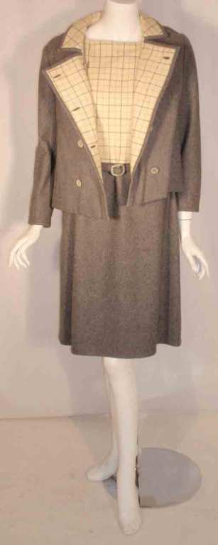 This is a two piece gray and cream wool coat and dress set by Maggie Rouff, from the 1960's. The dress is sleeveless with a matching belt and zipper up the back. The coat is double breasted with a lining.

Measurements:

Jacket

Length