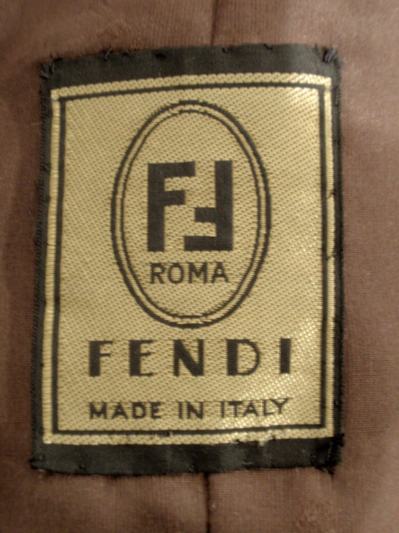 This is a wonderful fur coat from Fendi. It is from the 1980s and is in near mint condition. It is made of brown sheared fitch fur and has a cocoon style and big mutton sleeves with shoulder pads. It is lined with a brown nylon lining with the Fendi