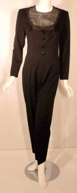 This is a very cute black long sleeve wool jumper with sheer silk inset with bow detail by Givenchy Couture from the 1980's. The jumper has four buttons up the front, boning at waist, and a zipper up the back. Fully lined. 

Measurements

Size: