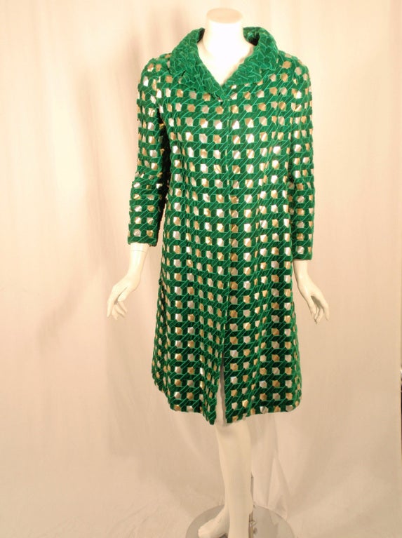 This is a flashy coat from Irene Gahlzine. It is made of green velvet and silver and gold ribbon, loosely woven in a basket weave, with a solid green collar. it is lined in a matching green silk.

Measurements: 
Bust: 40