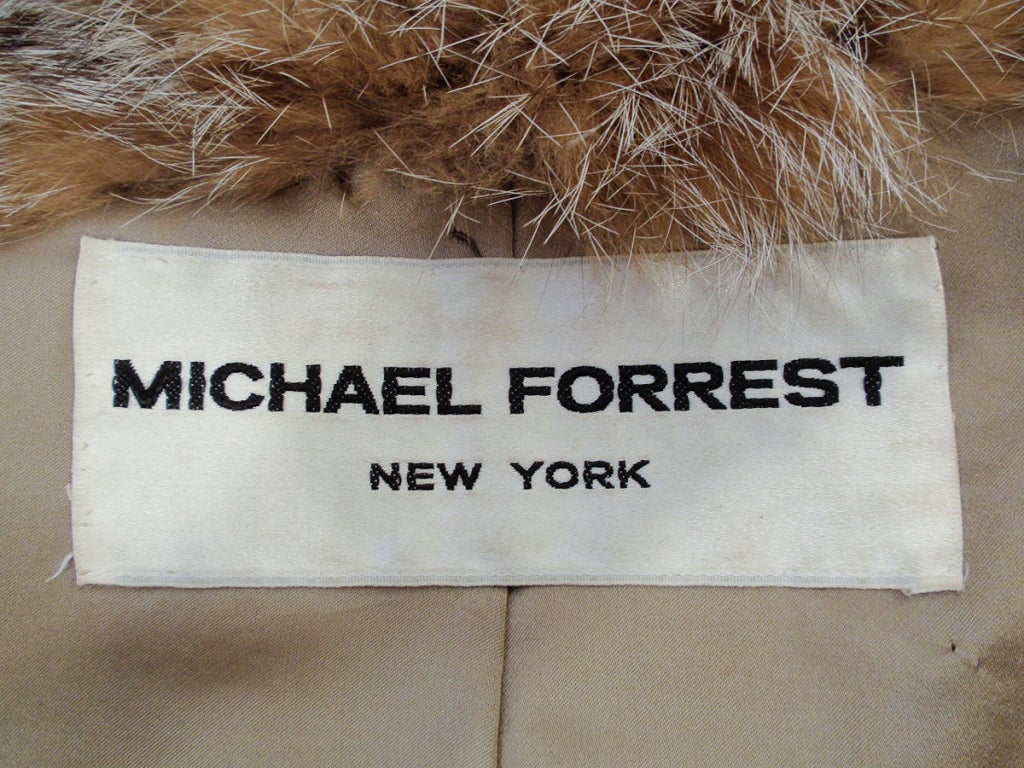 This fantastic Lynx coat from Giorgio Sant 'Angelo for Michael Forrest circa 1970's features a full collar that can be worn up for drama or down and demure. Fully lined in taupe satin with side slash pockets and hook and loop closures. 
Fits like a