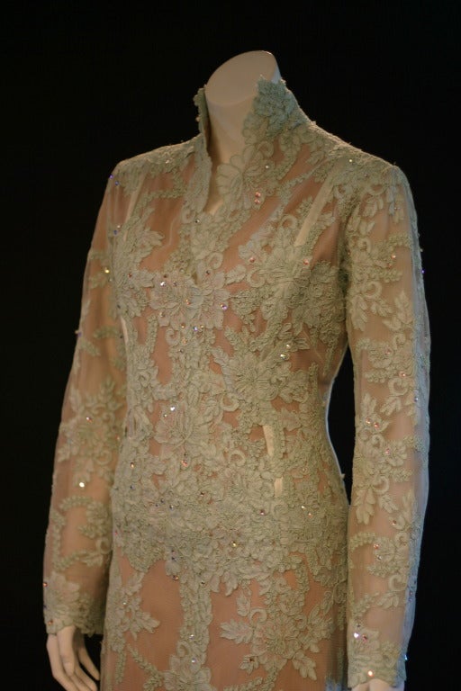 This is a new, with tags evening gown from the designer Juan Carlos Pinera. Original price, $2998.

This gorgeous gown features a mint green lace overlay on a nude colored lining. The gown has a majestic appeal to it, with beautiful crystals