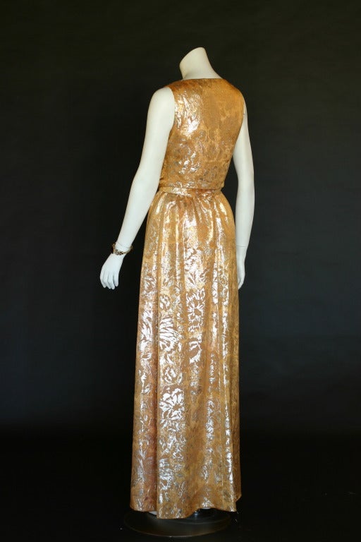 This is a unique gown from Oscar de la Renta in size 10 that could fit a size 6-10 well. 

It is gold lame silk material and gives off a lot of shine- very elegant. 

The design is interesting as it is a back to front style. The two sashes come