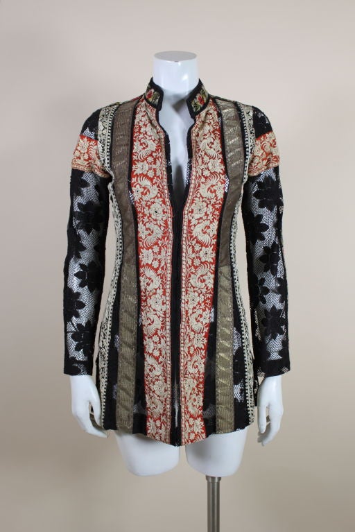 Fantastic 1960's Thea Porter Couture tunic is made from a wonderful cotton floral lace. Panels of embroidered ribbon are hand appliquéd along the front of the tunic with such motifs as roosters and multicolored flowers, along with strips of art deco