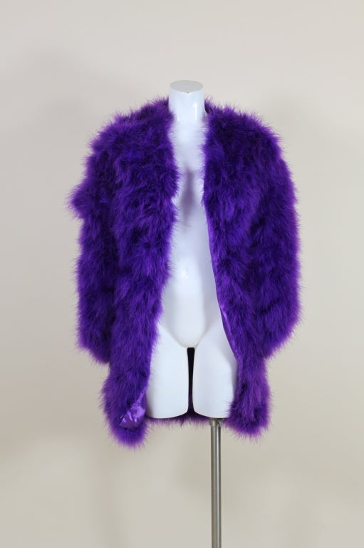 Absolutely fabulous, totally glamorous jacket from Bill Tice is made from lush, electric violet marabou feathers, hand sewn on a purple satin ground. This piece looks as though it was made for Studio 54! Fully lined.