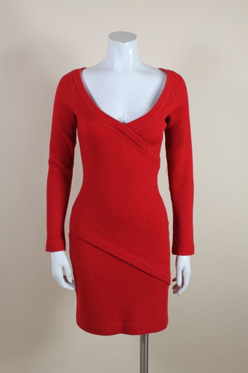 Sexy, body conscious illusion wrap dress from Parisian designer, Patrick Kelly is made from a vivid red textured wool knit. Asymmetrical seaming is accented by topstitched bands that wrap around the figure. <br />
<br />
Tagged a size Medium<br