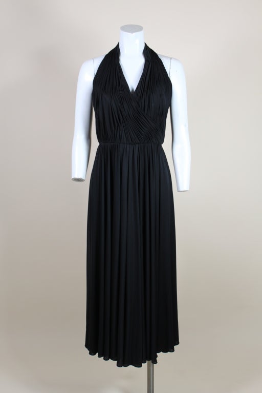Fabulous halter dress from Victor Costa is made from slinky jersey gathered into fine hand tacked pleats. Swingy skirt hits below the knee. Back zipper. <br />
<br />
Measurements-<br />
<br />
Bust: 34
