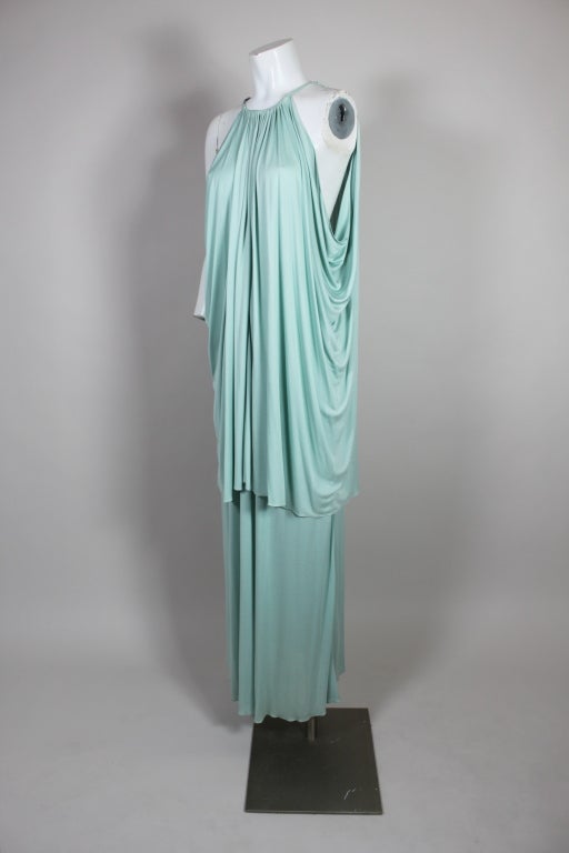 Fantastic Studio 54 era ensemble from Scott Barrie is made from luxe lightweight aqua jersey featuring a Grecian draped tunic over a maxi skirt. Tunic has an open back that ties at the neck with delicate radiating gathers. Skirt sits high on the