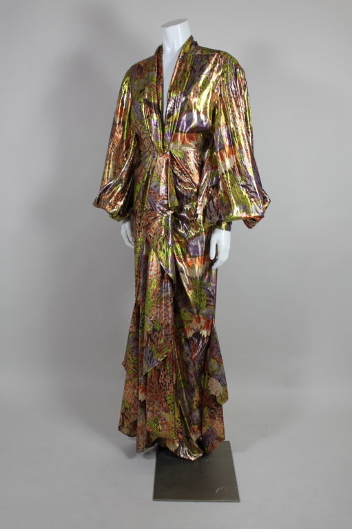 Absolutely stunning silk lamé gown from Thierry Mugler is made from a fantastic tropical floral in jewel tone shades of coral, violet, lime and accents of cream. The silhouette is inspired by the Hollywood screen sirens of the 30’s and 40’s, with