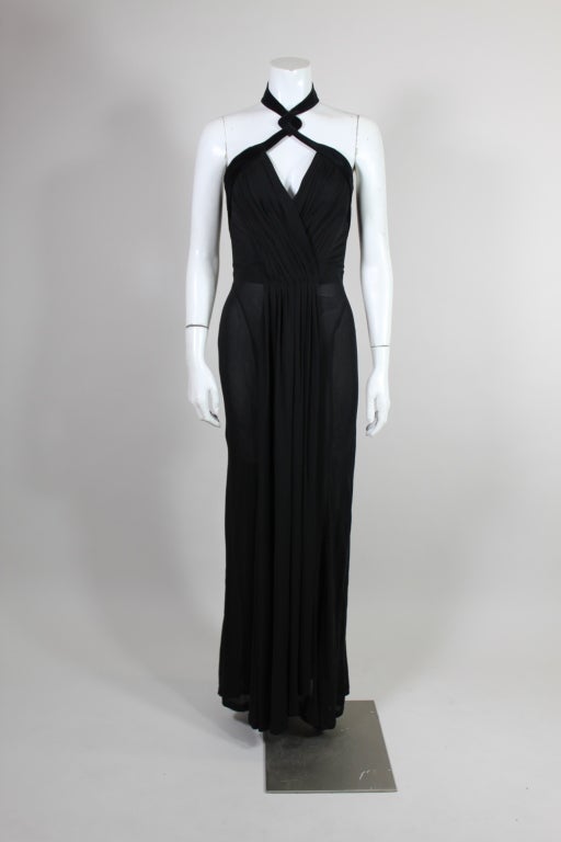 Stunning gown from Thierry Mugler is made from luxurious silk jersey pleated and sculpted to hug the body. Gown has a pleated criss-cross neck built upon a structured foundation. It's edged in black velvet that forms a sexy halter neck. Skirt has
