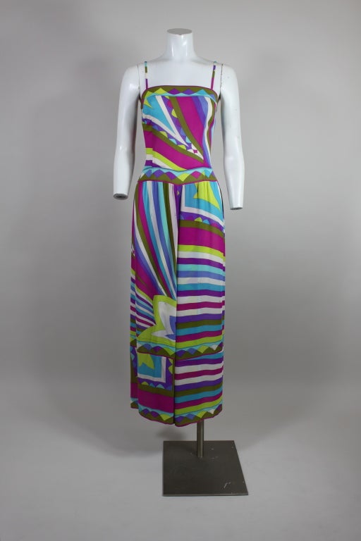 Fantastic 1960’s Pucci jumpsuit is made from silk crepe chiffon printed with an iconic psychedelic graphic in shades of violet, fuchsia, lime, olive, turquoise and white. Jumpsuit has a banded, contoured waist and fabulous palazzo pants. Fully lined