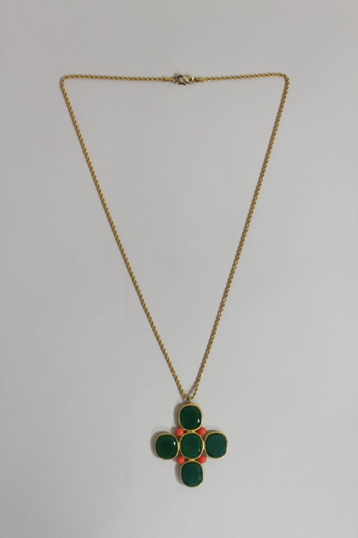 Statement necklace by great costume jewelry designer Kenneth Jay Lane.  Classic cross design with faceted green glass center stones and coral tone off center beads.