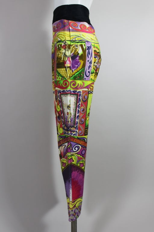 This fabulous pair of cotton trousers from Versace features a whimsical, dreamy equestrian print with characters that look as though they belong in a painting by Marc Chagall. The painterly print is done in bold berry shades and acid neons. Trousers