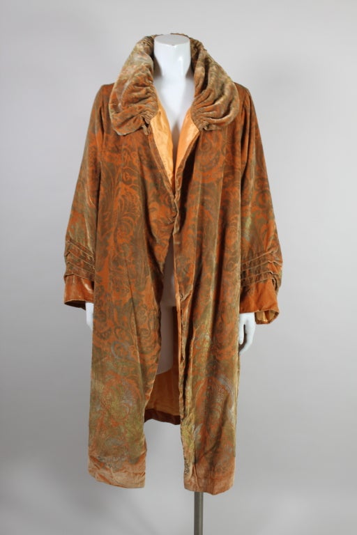 This fantastic 1920's coat from iconic Italian artist-designer Maria Monaci Gallenga is made from sumptuous apricot silk velvet stenciled with a decadent metallic gold floral paisley. Coat has a dramatic funnel neck collar with hand pleating around