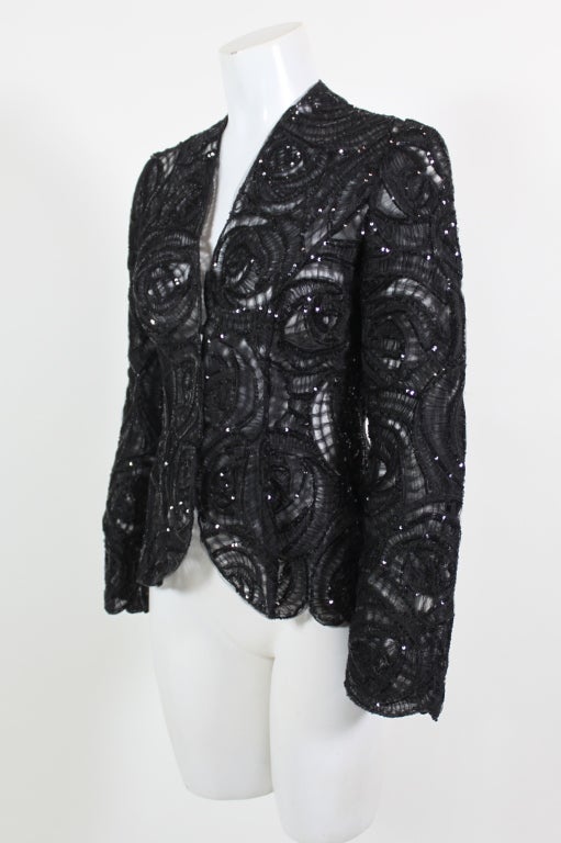 This elegant evening jacket from Giorgio Armani is made from delicate tulle that has been shaped into an allover deco rosette motif. Tulle is ruched and pleated within each flower for added dimension. Shimmering jet black micro sequins are sewn