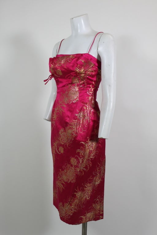 Gorgeous 1960’s ensemble from Sophie of Saks features a cocktail dress made from exquisite hot pink and metallic gold silk brocade. The triple layered neckline has a bust shelf accented by two delicate satin ribbons. Coat is done in a sleek 60’s