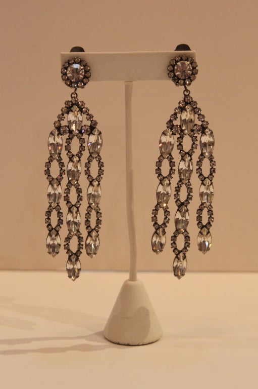 These shimmering chandelier beauties from costume jeweler extraordinaire Kenneth Jay Lane are made from prong-set faceted crystal clear rhinestones. Clip-on. 

Measurements-

Length: 4.25