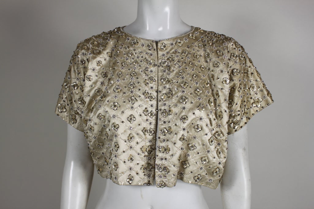 Stunning lifetime Christian Dior evening bolero in cream silk-satin encrusted in delicate iridescent sequin and tiny rhinestones. This is a masterpiece of construction and detail. From the Autumn/Winter collection of 1957. This would be wonderful