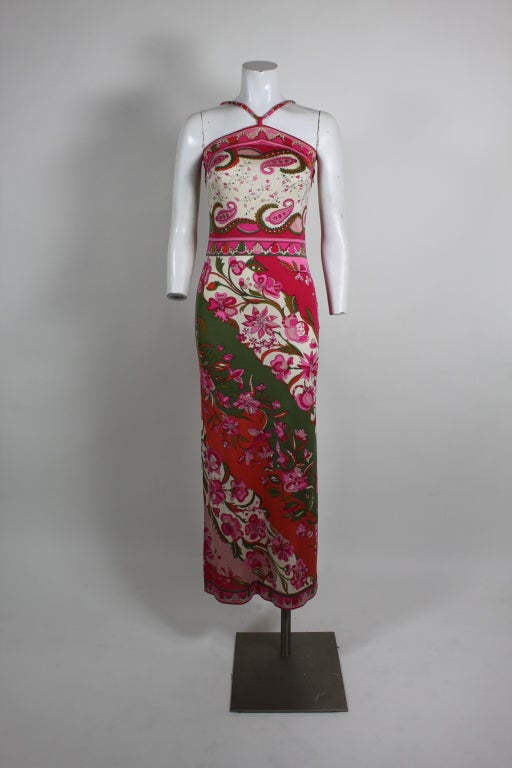 1960s Emilio Pucci maxi dress with the designer's iconic psychedelic floral print  done in silk jersey. Halter neck bodice with straight drop.  Classic Pucci print in white, green, pink, and fuschia.