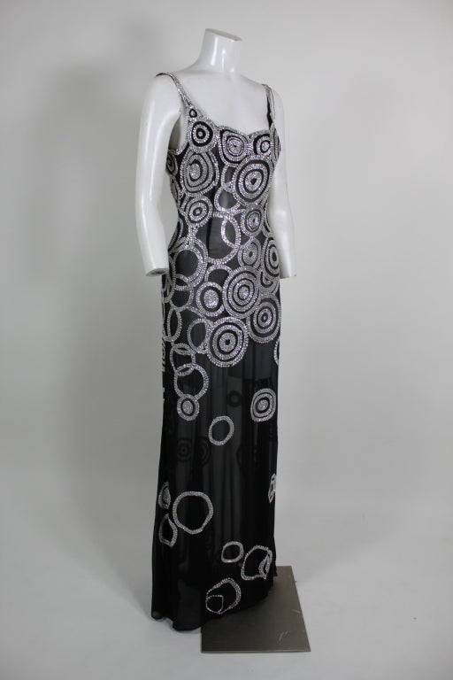 This fabulous custom made gown is done on gorgeous sheer black silk chiffon with hand applied rhinestone beads done in concentric circles.  Completely sheer and body hugging.