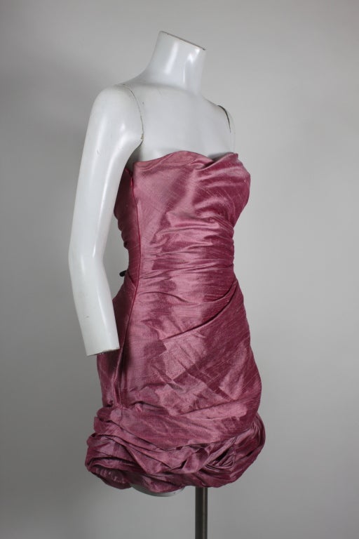 Blush pink strapless ruched hem party dress from Giorgio. Intricate ruching gives this dress a modern edge. Side zip.